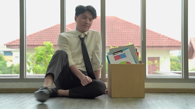 The dismissed company employee was sad. He subsided, wanting to be exhausted by the glass wall.
