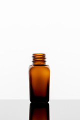 A bottle of essential oil on a white background