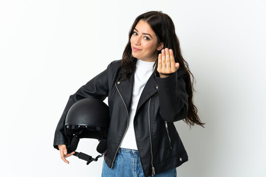 Woman holding a motorcycle helmet isolated on white background inviting to come with hand. Happy that you came