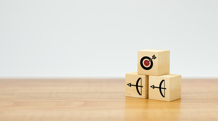 stacked cubes with arrow symbols pointing towards a target on white background