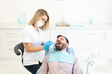 Dentist Checking Teeth Of Patient
