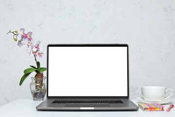 Fototapeta premium Laptop with blank empty screen on white table. feminine interior. mockup