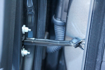 Close up of a car door hinge