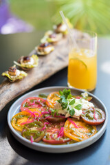 Heirloom Tomato and Cream Cheese Salad with Red Onion and  Basil. Summer Appetizers and Beverage
