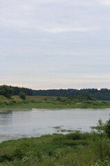 Cloudy day with clouds on the river in the countryside