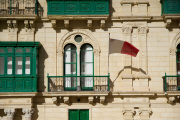 VALLETTA, MALTA - DEC 31st, 2019: Malta flag, city street and life, urban view and architecture