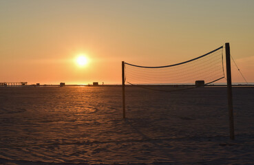 Obraz premium Beach Volleyball Court Net at Sunrise