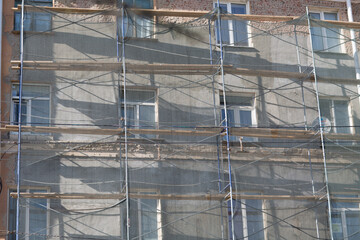 Scaffolding on building house in the city.