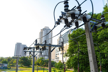 Pillars with wire power line against the background of the city