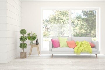White living room with sofa and summer landscape in window. Scandinavian interior design. 3D illustration