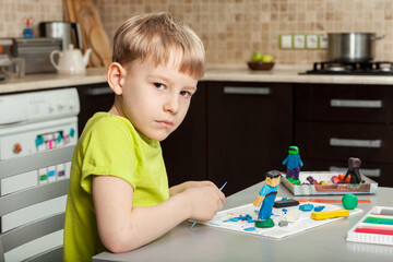 An Outbreak Of Coronavirus. Suspension and closure of kindergartens. The boy studies at home. The COVID-19 pandemic forces children to spend all their time at home.