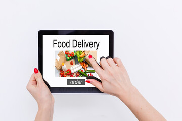 Girl ordering pizza online on smartphone, with table and coffee and plant in background