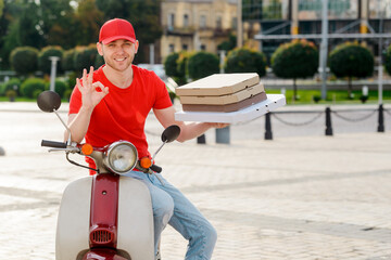 Cheerful guy showing Ok sign to ensure that order will be delivered in time