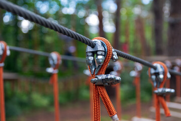 Rope holding a log bridge, part of the cableway. Close-up. Extreme sport.