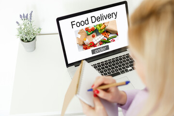 Close up woman sitting and orde food online on laptop computer in add to cart function webpage at coffee shop,Digital marketing concept.digital lifestyle living