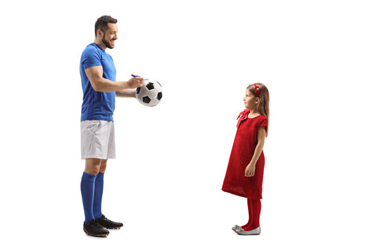 Footballer Signing An Autograph On A Soccer Ball For A Little Girl Fan