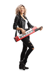 Fototapeta premium Full length portrait of a woman in leather clothing playing a keytar synthesizer