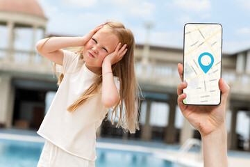 Online navigation.A girl holding her head with her hands,lost in the street.In the background,a...