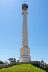 Monument to the discoverers in La Rabida, Huelva. Large column with an orb at its top in an environment surrounded by gardens. Huelva, Andalusia, Spain.