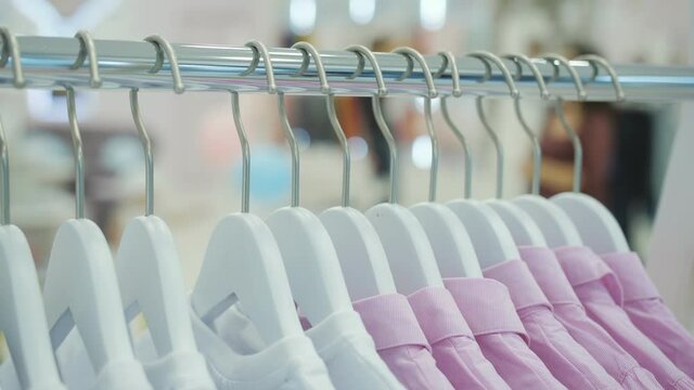 Close-up of children's clothing hanging on hangers in a children's clothing store.