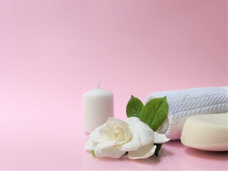 Fototapeta na wymiar Spa setting and Spa background composition with white gardenia flower on pink background.