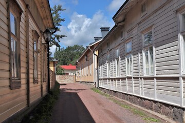 A small street with traditional colorful wooden houses on a wonderful summer day. The photo is taken in Tammisaari town, Finland.