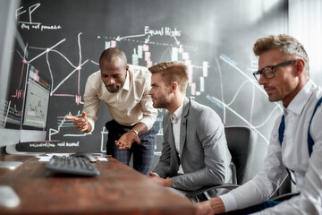 Contagious ideas. Businessmen, traders in shirts discussing strategy and collaborative process during brainstorming in office. Diverse employees working in team on managing and marketing solution.