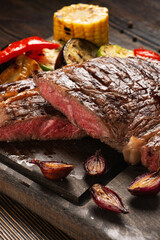 Medium Rare Ribeye steak on wooden board