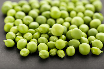 Green peas on black background