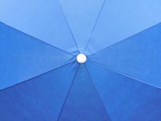 
Background: blue beach umbrella photographed from above.