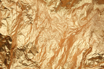 Abstract embossed textured background in gold color. Gift wrapping paper close up