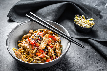 Obraz na płótnie Canvas Chicken Stir-fry. Wok udon noodles. Traditional asian food. Black background. Top view