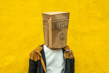 the boy has a bag on his head that says no racism