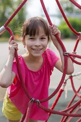 Fotobehang cute girl in pink t-shirt in the playground © Albert Ziganshin