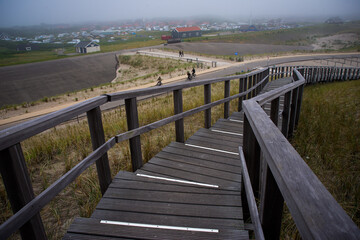 Fototapeta premium Wooden stairs path over the Dunes in Petten, Netherlands