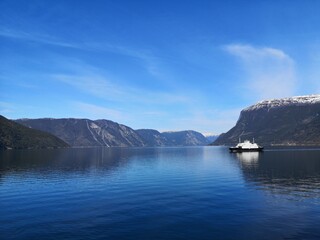 Fototapeta na wymiar Ferry surrounded by mountains