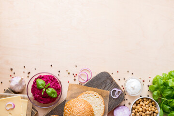 Top view ingredients for cooking vegan burgers on light wooden background with copy space flat lay