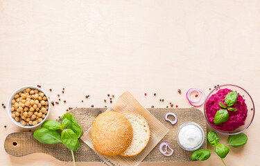 Top view ingredients for cooking vegan burgers on light wooden background with copy space flat lay
