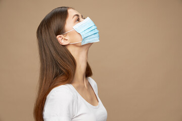 Attractive woman in white shirt in a protective mask health 