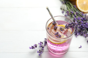 Fresh delicious lemonade with lavender on white wooden table. Space for text