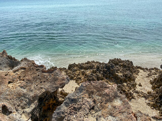 A rocky beach with clear turquoise water in Stuart, FL