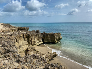 Fototapeta na wymiar A rocky beach with clear turquoise water in Stuart, FL
