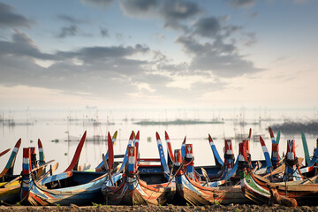 Wooden boat at Ubein Bridge during sunrise, Mandalay, Myanmar, Burma (Worlds longest wooden bridge)