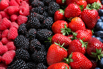 Mix of different ripe tasty berries as background, closeup view