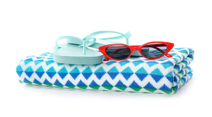 Bright towel, sunglasses and flip flops on white background. Beach objects
