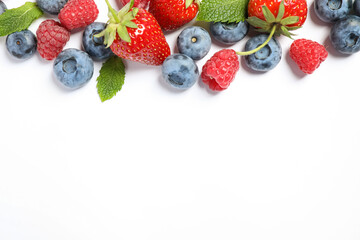 Mix of fresh berries on white background, flat lay