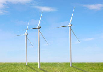 Fototapeta premium Alternative energy source. Wind turbines in field under blue sky