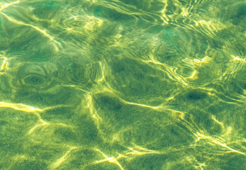 crystal clear still deep water in warm tone green  yellow copy space for your text 