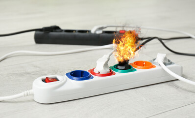 Inflamed plug in power board - result of electrical short circuit