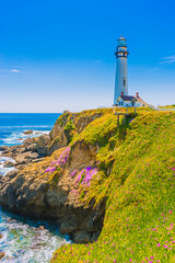 Pigeon Point Lighthouse, Landmark of Pacific Coast Highway (Highway 1) at Big Sur, surrounded with colorful wildflowers in spring time, California